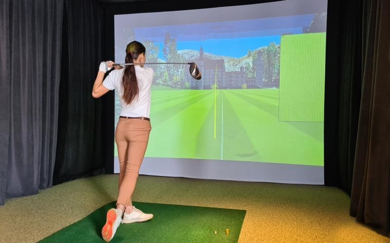a person using a golf simulator
