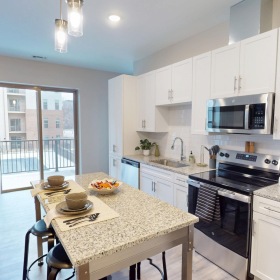 a kitchen with a table and chairs
