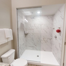 a bathroom with a shower, toilet and sink