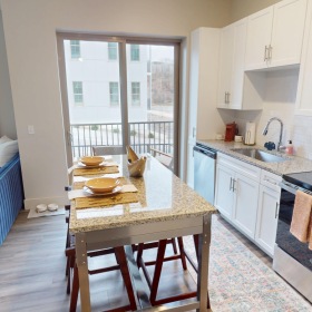 a kitchen with table and chairs