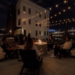 people sitting around a firepit outside